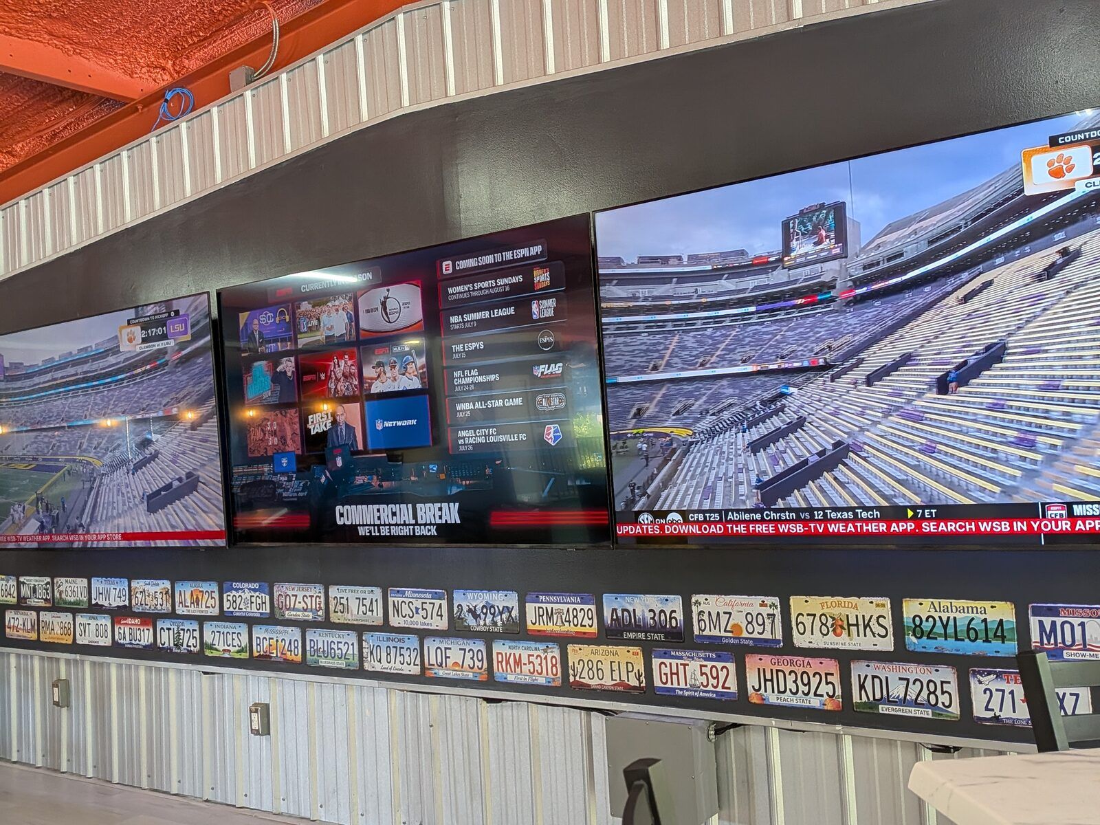 A game on the screens at Platform 32 with seating in front